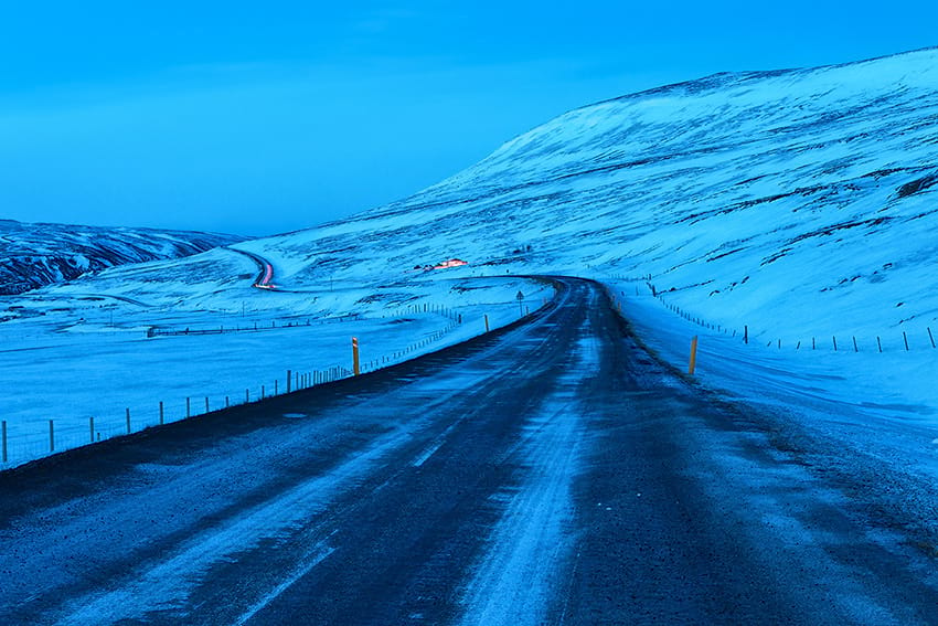 Icy and snowy road. Driving in the dark at night