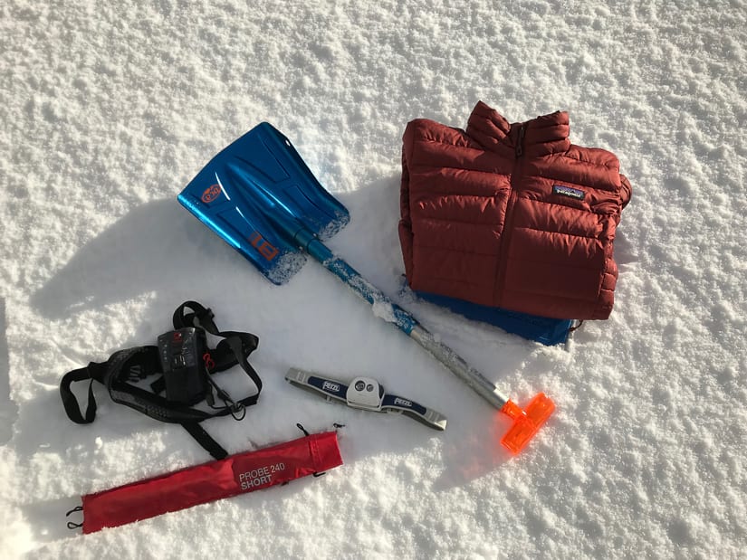 Essential winter gear: Transceiver, shovel, beacon, headlight, down jacket