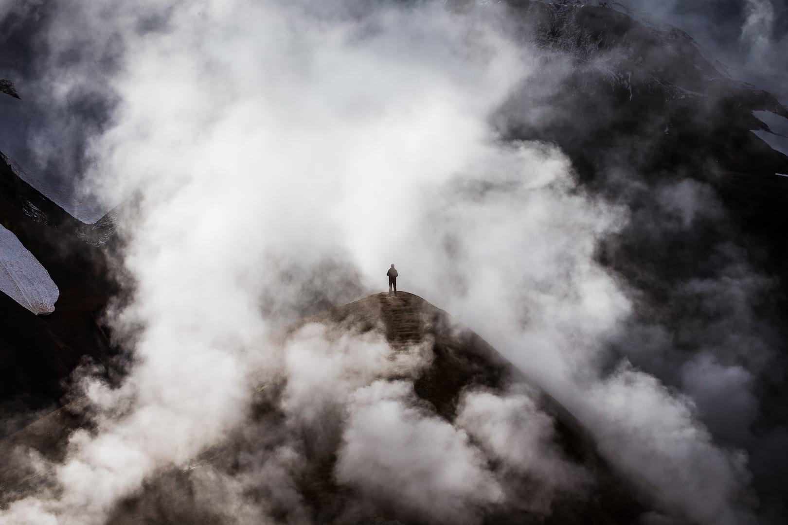 Lonely man standing in the steam on the Icelandic Highlands