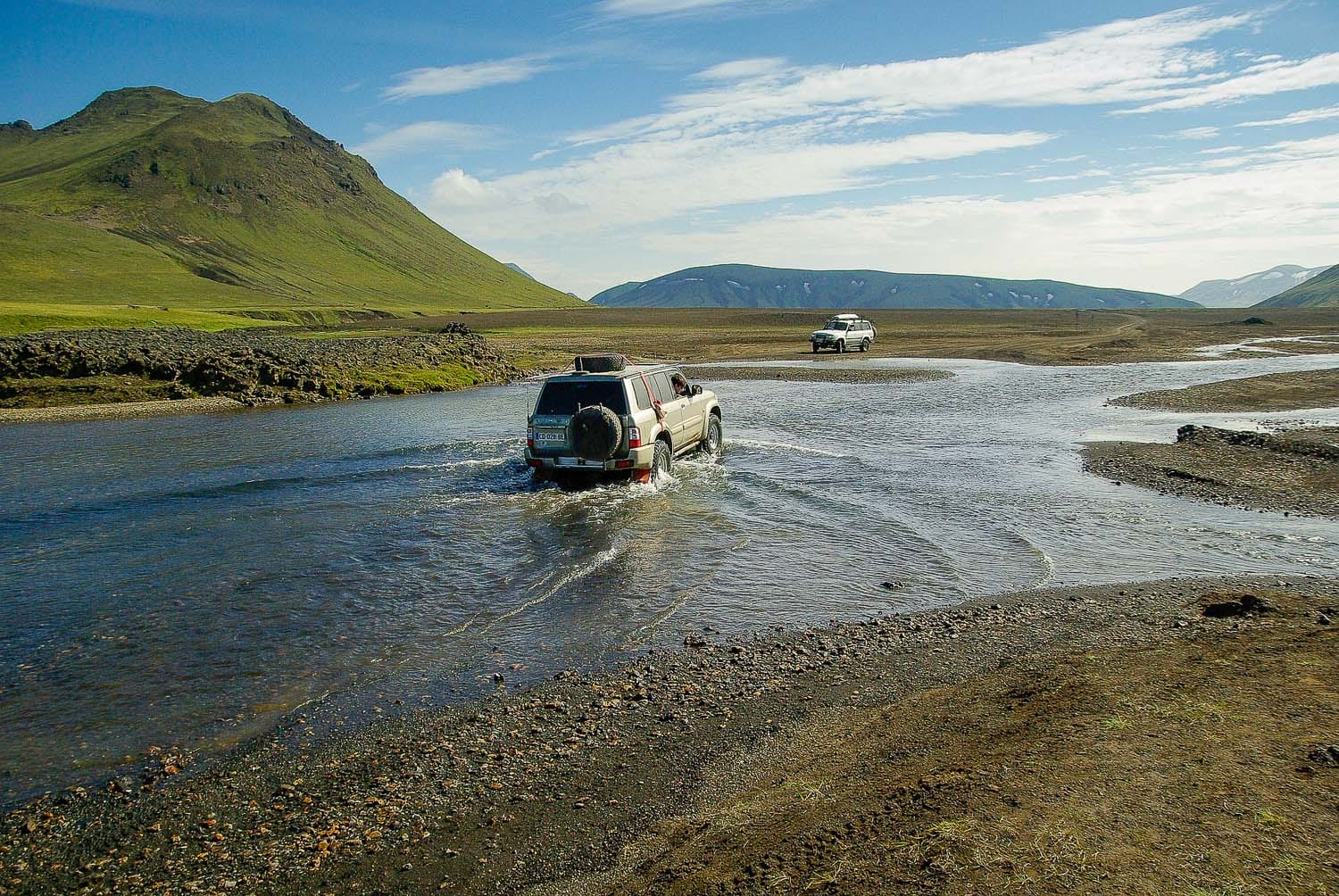 Superjeeps crossing rivers in Landmannalaugar