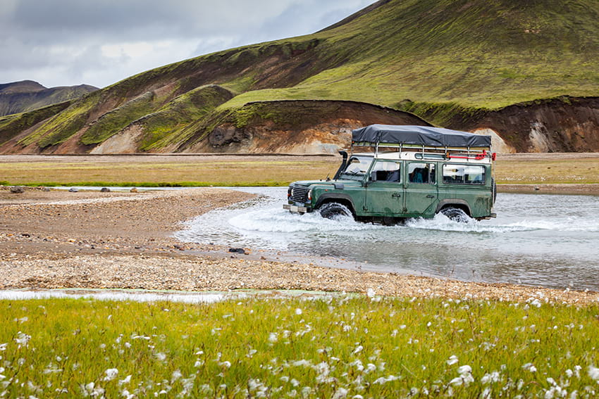 Jeep crossing unbridged river in Landmannalaugar, Iceland 